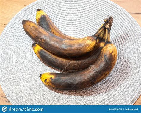 One Dark Spoiled Banana On And A Bunch Of Fresh Bananas On A Bright