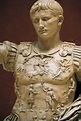 a statue of a man with his arms outstretched in front of him, wearing armor
