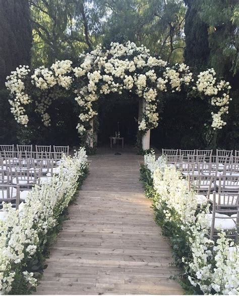 Lining The Aisle With Images Garden Weddings Ceremony Wedding Altars Greenery Wedding Decor