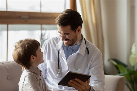 Male Pediatrician Checkup Little Boy Patient Using Tablet Stock Photo
