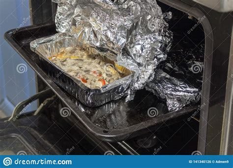Baked Meat with Mushrooms in Foil in the Hot Oven Stock Photo - Image ...