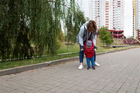 Young Mother Walks With Her Little Son In The Park Stock Photo Image