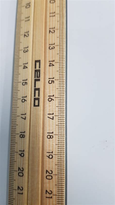 Wooden Ruler With Metal Strip Stuck On Stationery