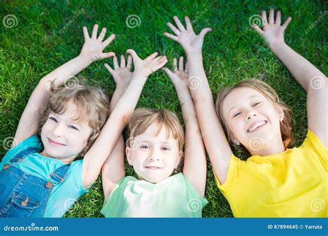 Group Of Happy Children Playing Outdoors Stock Image Image Of Grass