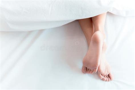 woman feet on the bed under white blanket sleeping and relax concept stock image image of