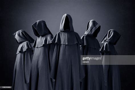 Group Of Five Scary Figures In Hooded Cloaks In The Dark High Res Stock