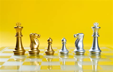 Golden And Silver Chess Pieces On Chess Board Stock Photo Download