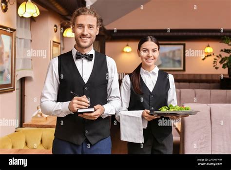 Portrait Of Young Waiters In Restaurant Stock Photo Alamy