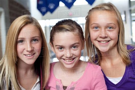 Close Up Portrait Of Three Teen And Pre Adolescent Girls Smiling