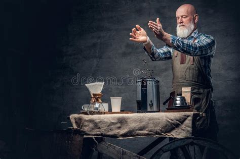 Old Man Barman Filling Coffee Machine With Coffee Beans Stock Photo