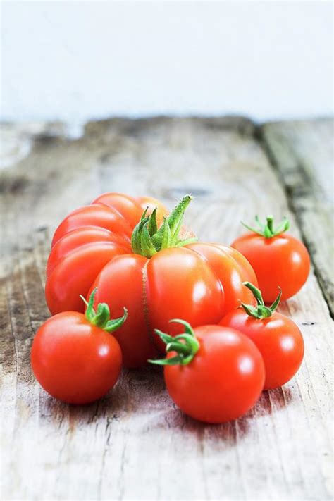 Various Types Of Tomatoes On Wooden Background Photograph By Victoria