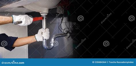 Plumber Fixing White Sink Pipe With Adjustable Wrench Stock Photo