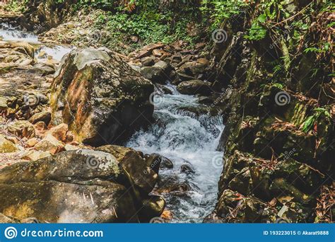 Jungle Waterfall Cascade In Tropical Rainforest With Rock And Turquoise