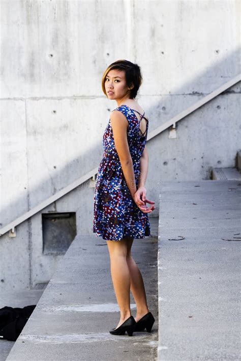 Asian American Woman In Floral Dress Looking Over Shoulder Stock Image Image Of Cute Girl