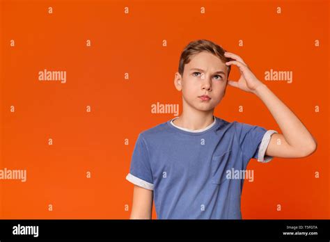 Pensive Teenage Boy Looking Up With Thoughtful Expression Stock Photo