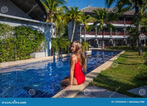 woman in red swimwear sitting on the board of pool editorial stock image image of happy