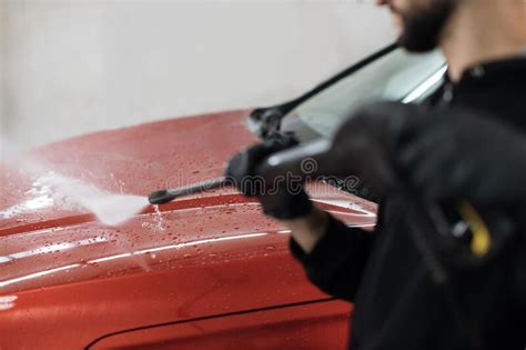 Cropped View Of A Man Worker Cleaning Modern Red Automobile With High