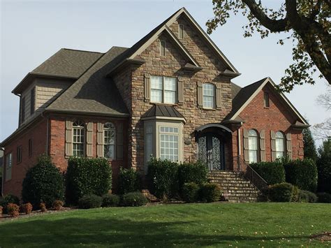 Red Brick And Stone Combine With Rock Taupe Gray Roof And Shutters To