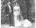 an old black and white photo of a bride and groom standing in front of ...