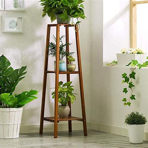 A Tall Wooden Plant Stand With Potted Plants