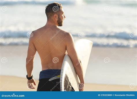 An Athletic Man Surfer With Naked Torso Standing By The Ocean Stock Image Image Of Wetsuit