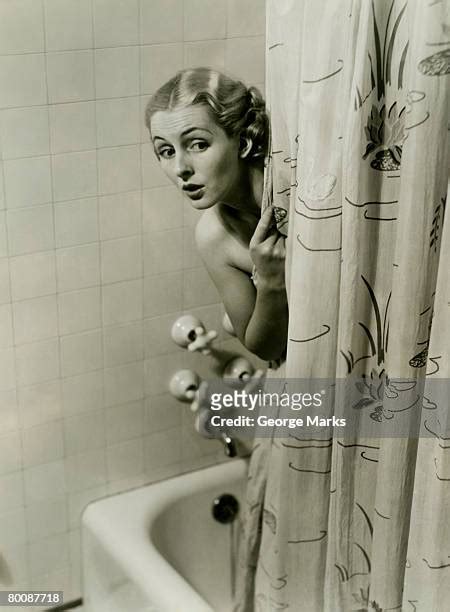 peaking behind shower curtain photos and premium high res pictures getty images