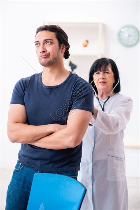 Photo Of Young Male Patient Visiting Aged Female Doctor Picture And Hd