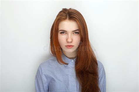 Young Serious Angry Redhead Beautiful Woman In Shirt Portrait On A