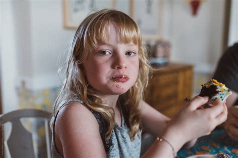 Young Girl Eating Cupcake With Messy Face By Carey Shaw