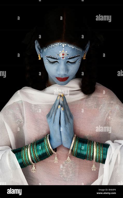 Indian Girl Face Painted As The Hindu Goddess Sita Against A Black