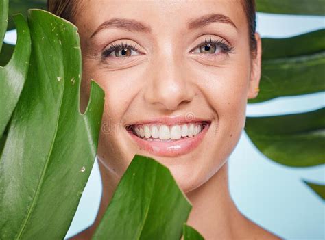 Portrait Skincare And Palm Leaf With A Model Woman Posing In Studio On