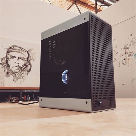 A Computer Tower Sitting On Top Of A Wooden Table Next To A Wall With