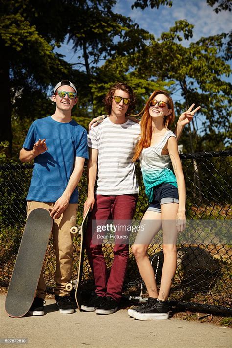 Group Of Teenage Skateboarders Hanging Out At Skatepark High Res Stock