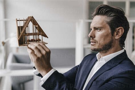 Architect Examining Architectural Model Stock Photo