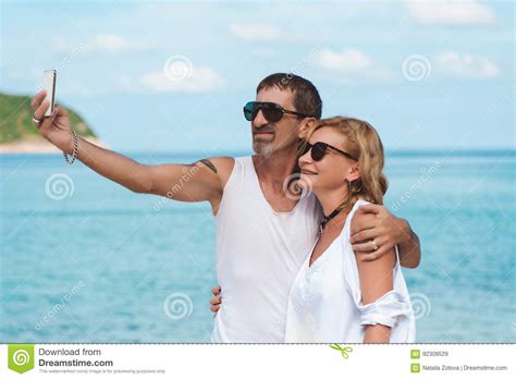 Portrait Of Mature Smiling Couple Taking A Selfie At The Beach Stock Image Image Of Beach