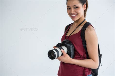 Happy Female Photographer Standing In Studio Stock Photo By Wavebreakmedia