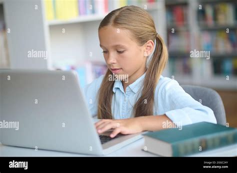 Focused Young Girl Using A Gadget In Learning Stock Photo Alamy