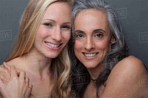 Young Woman And Mature Woman Hugging Stock Photo Dissolve