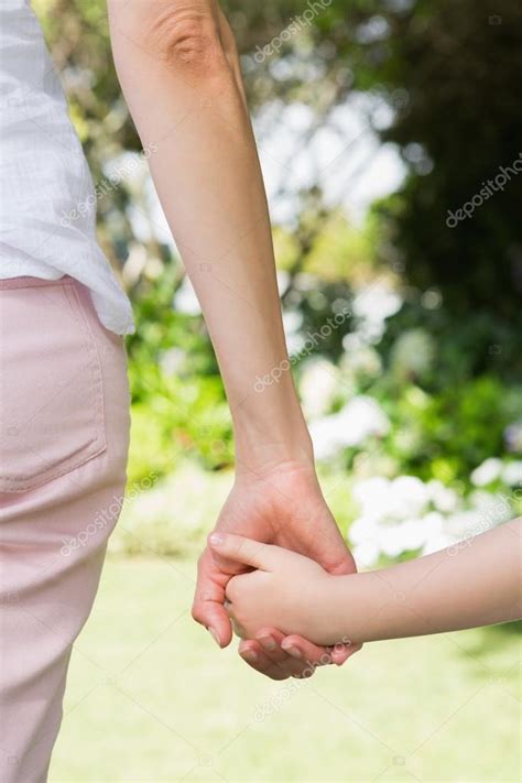 Mother And Daughter Holding Hands — Stock Photo © Wavebreakmedia 68954673