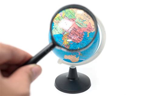 Hand Holding Magnifying Glass Over Earth Globe Stock Photo Image Of