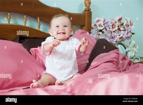 Cute Happy Laughing Baby Playing On Bed Stock Photo Alamy