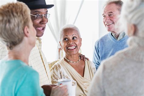 Group Of Seniors Socializing Over Coffee Stock Photo Download Image