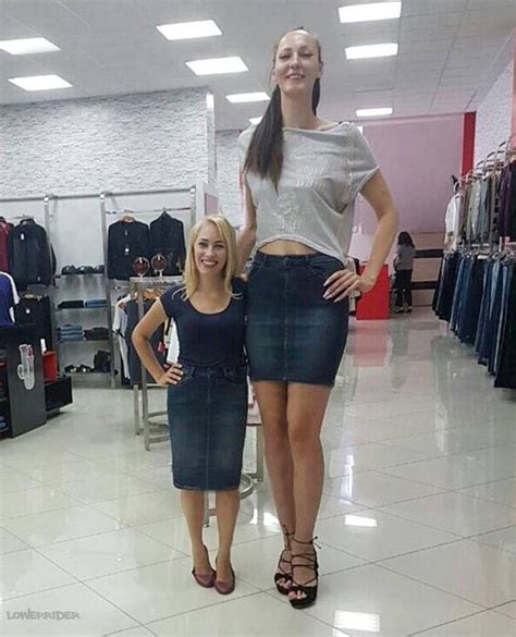 Two Women Standing Next To Each Other In A Clothing Store