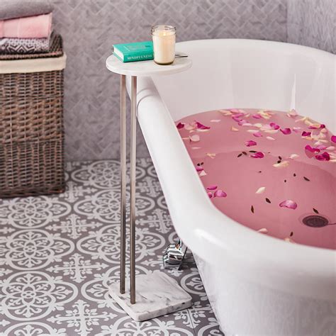 Get ready to relax in this stunning bathroom boasting a roll top freestanding tub placed on marble floor tiles beside a polished nickel floor mounted tub filler fixed next to a carved. The Dunelm bath side table is the new must-have bathroom ...