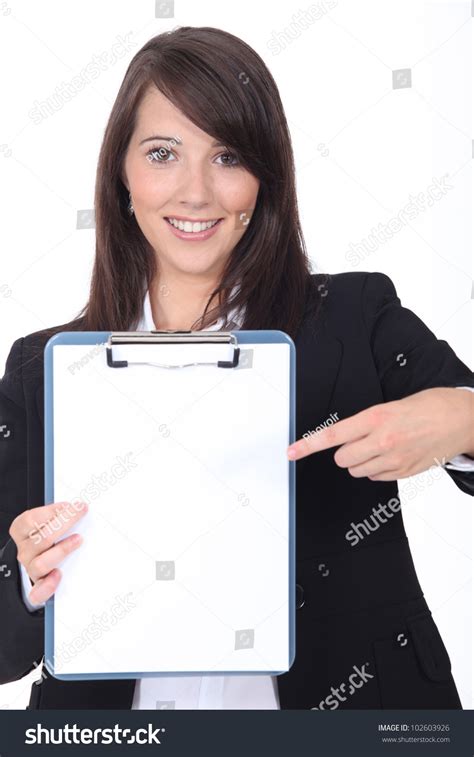 Young Secretary Pointing A Notepad On White Background Stock Photo
