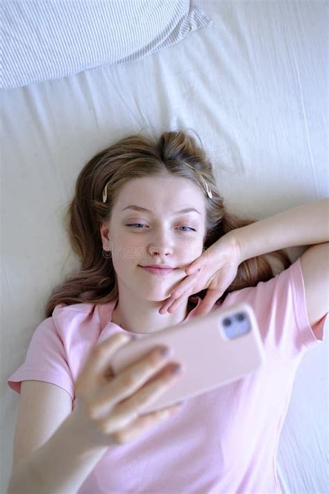 Cute Girl 15 18 Years Old Lying On The Bed Makes A Selfie View From Above Stock Image Image