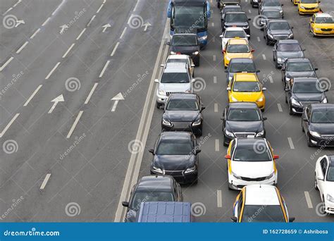 Cars Standing In A Traffic Jam On One Side Of A Busy Highway