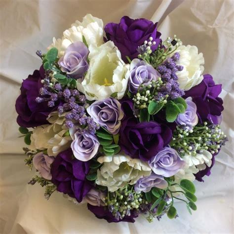 a brides bouquet of purple lilac and ivory silk roses and tulips flower bouquet wedding purple