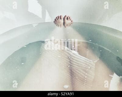 Legs Sticking Out Of Bathtub Stock Photo Alamy