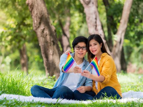 asian couples show the lgbt symbol and embrace each other with love and happiness 7542043 stock